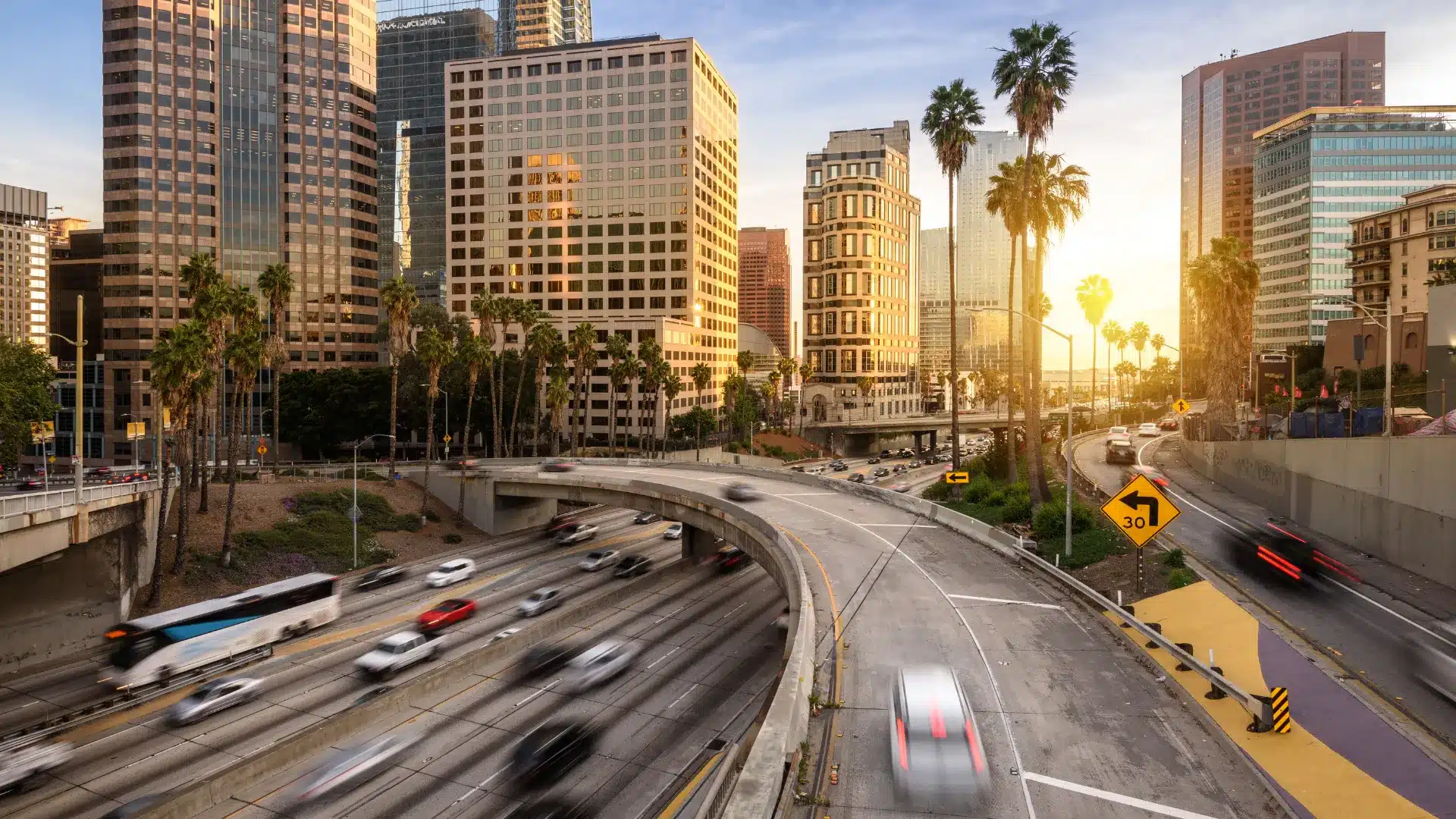 Downtown Los Angeles freeway traffic at golden hour