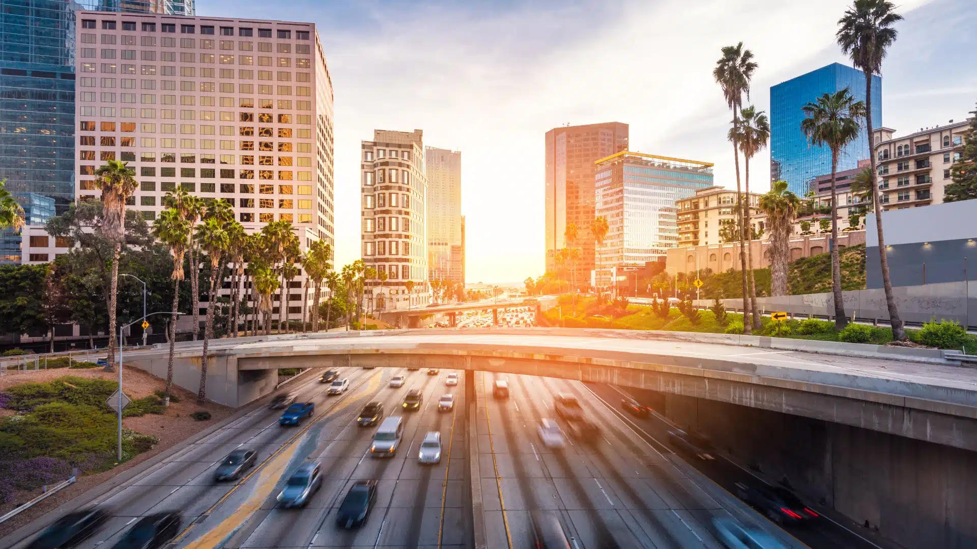 Los Angeles skyline and freeway with golden sunset